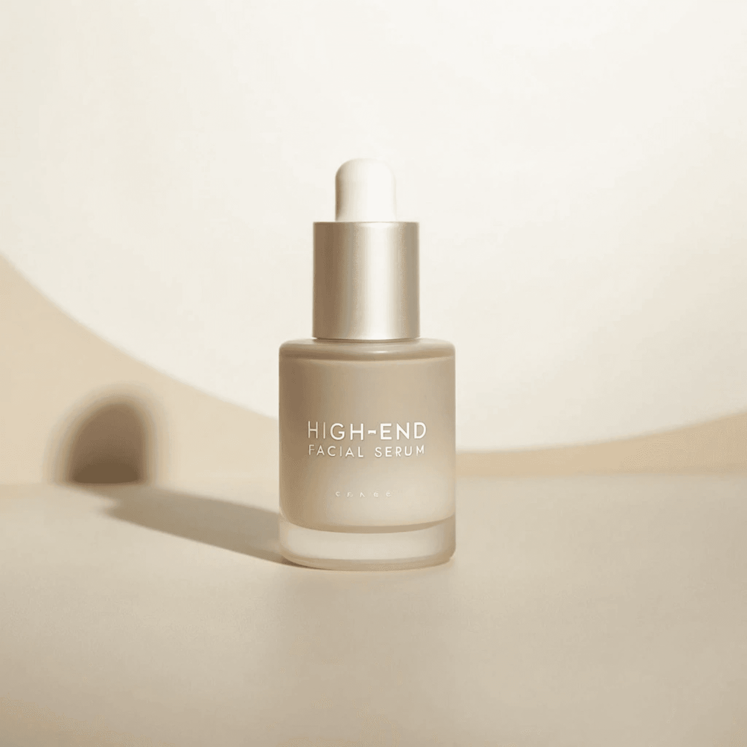 Frosted serum bottle with a silver dropper on a soft beige set